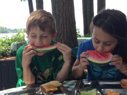 Migis Lodge kids eating watermelon 