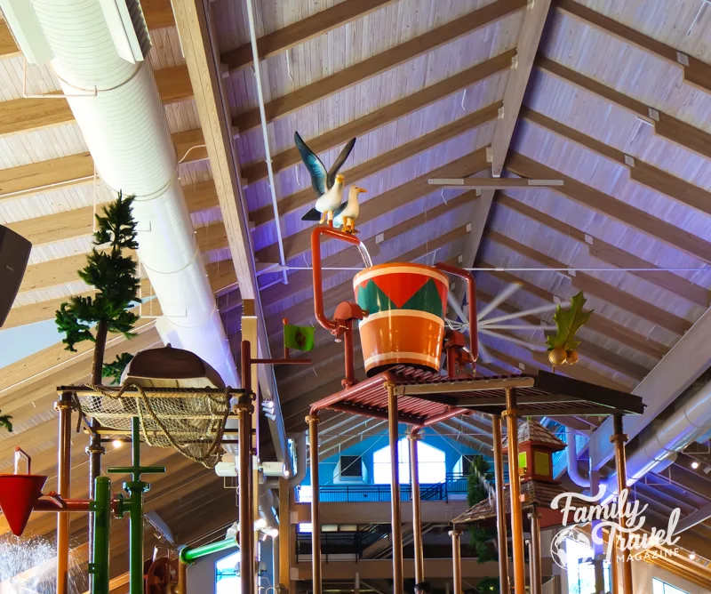 Water park feature with a large soaking bucket