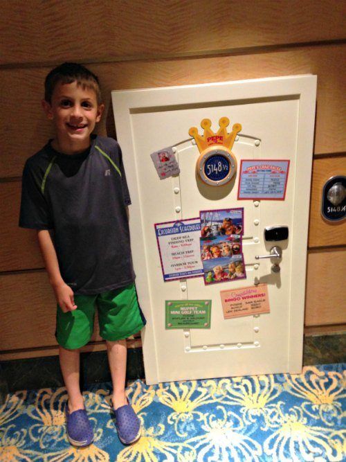 Pepes door with boy standing next to it 