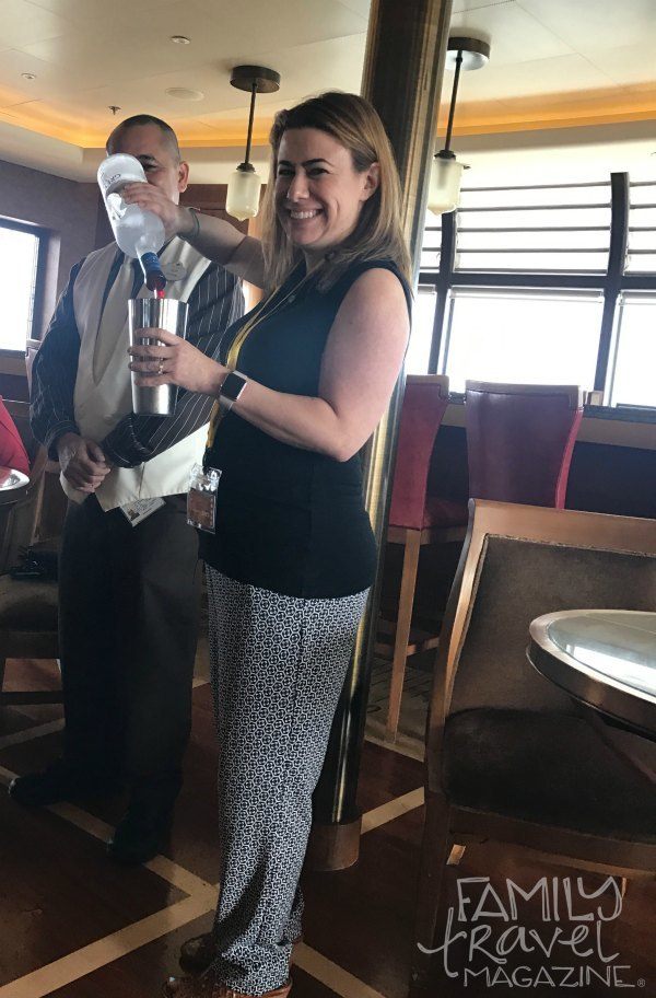 Woman mixing cocktail on the cruise 