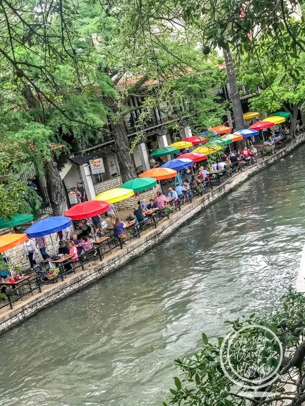 Umbrellas over tables at riverfront restaurant