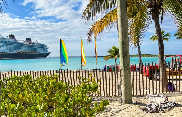 Disney cruise ship docked at Castaway Cay with water equipment in the foreground.