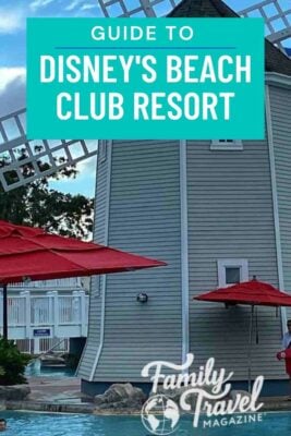 Gray windmill with red umbrellas near Beach Club pool