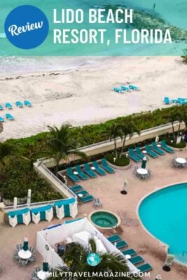 Pool area with chairs, in front of beach with lounge chairs