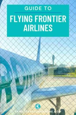 Frontier Plane parked at an airport, as seen through the jetbridge door.