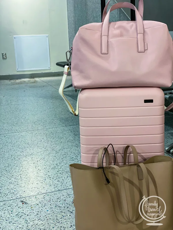 A stack of pink AWAY suitcases