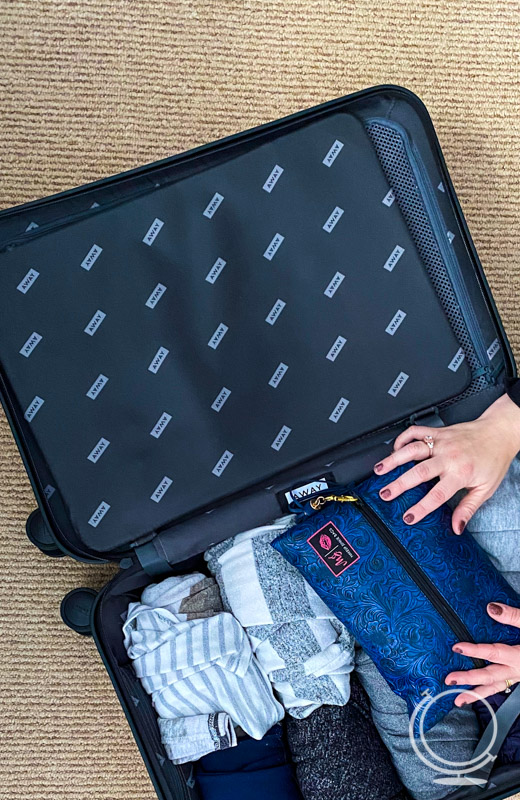 Packing a suitcase with rolled clothes