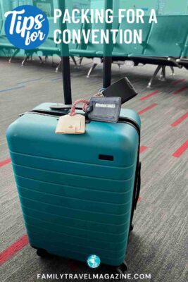 Green roller board suitcase at airport