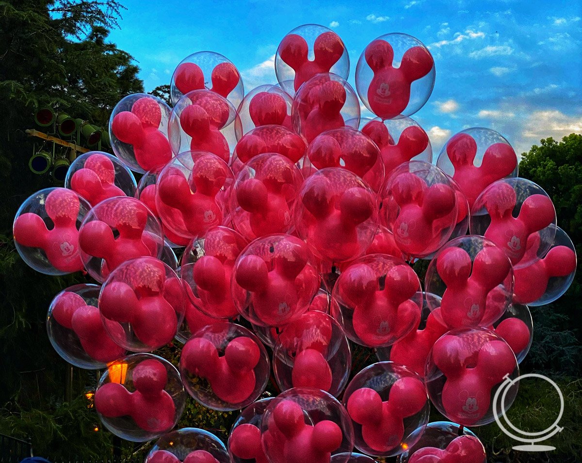 Pink Mickey balloons in the sky - "how many days in Disneyland"?