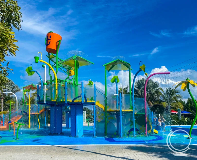 Mini waterpark area with bucket, splash pad, fountains, slide