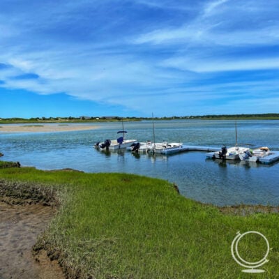 Beach with seagrass and docked boats