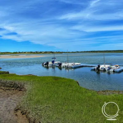 Beach with seagrass and docked boats