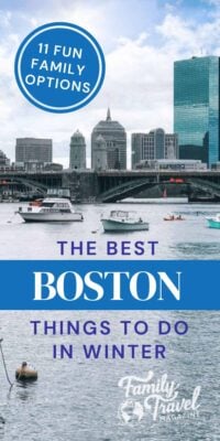 a body of water with boats in it and Boston buildings in background