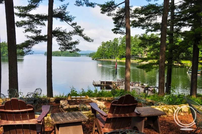 Wooden adirondack chairs overlooking pier on Sebago Lake