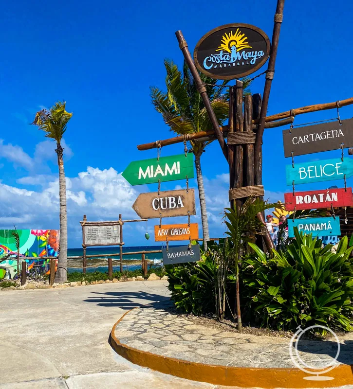 Sign at the Costa Maya cruise terminal showing the direction of locations including Miami, Cuba, New Orleans, Bahamas, Cartagena, Belice, Roatan, and Panama. 