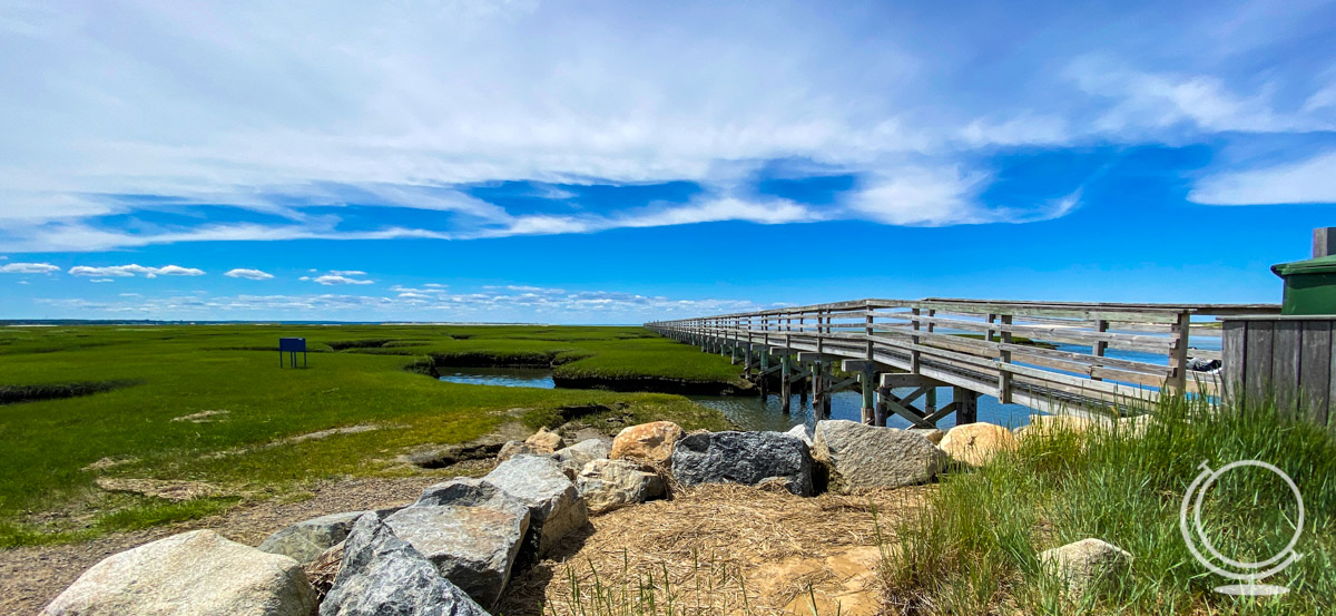 Gray's Beach boardwalk with sea grass and rocks in the foreground - beach in Yarmouth, one of the best Cape Cod Towns