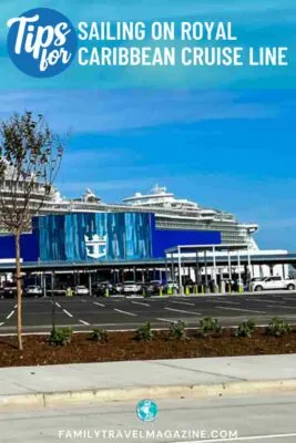 Royal Caribbean ship docked at cruise port with logo on building