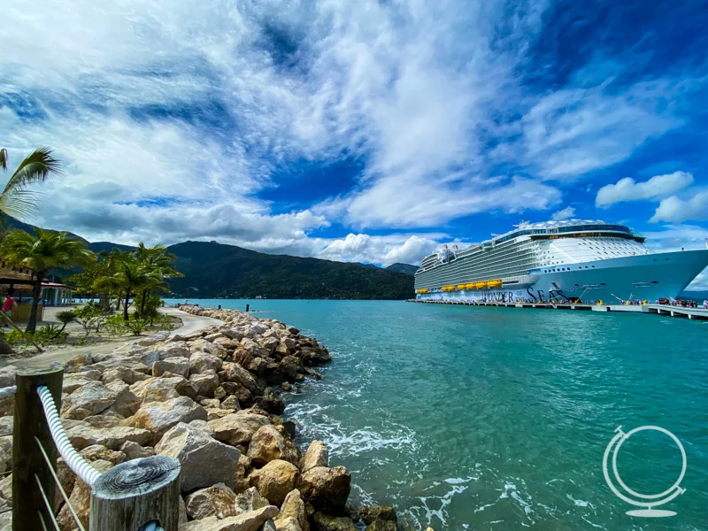 The Wonder of the Seas docked at Labadee with mountains and rocky coastline