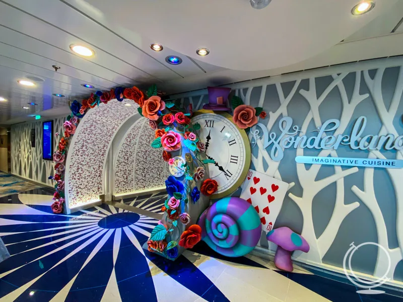 The entrance of Wonderland with colorful clock, flowers, mushroom, and card figures 