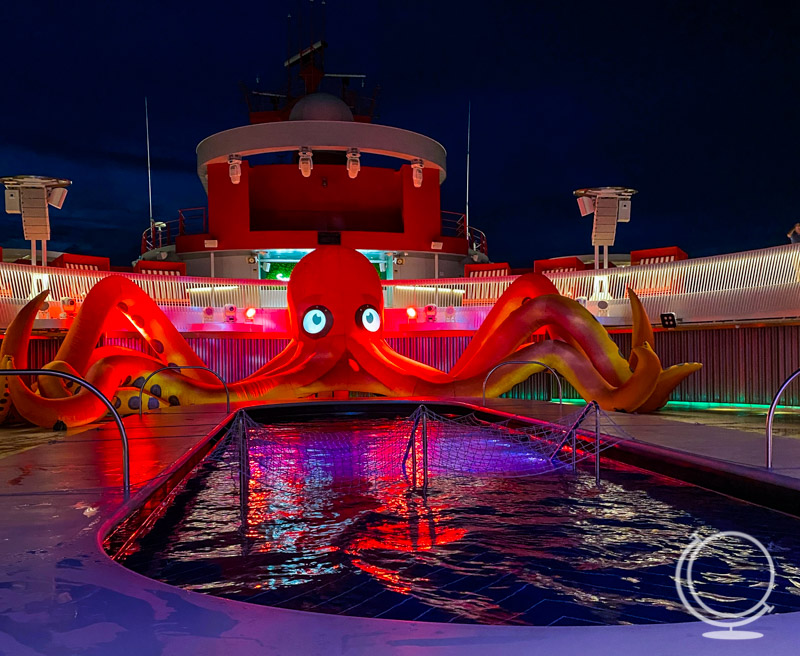 Huge inflatable octopus by the pool at night. 