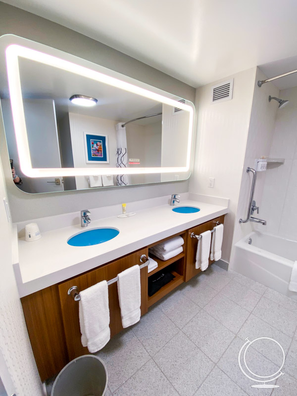 Double bathroom sinks and large mirror at HoJo Anaheim