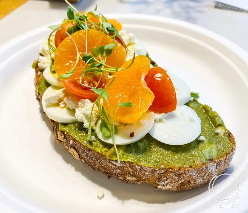 California Avocado toast with tomato, orange, feta, and egg