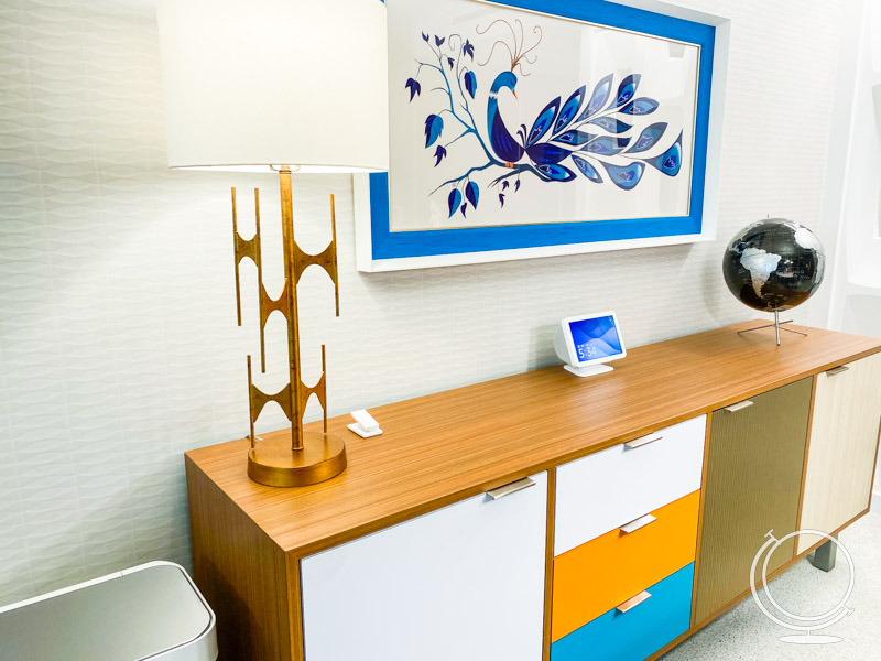 Mid century modern credenza with drawers and doors, a lamp, and a globe. 