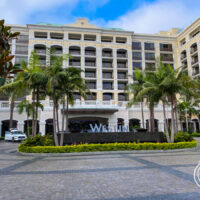 the exterior of the Westin Anaheim hotel showing building, palm trees, and Westin sign