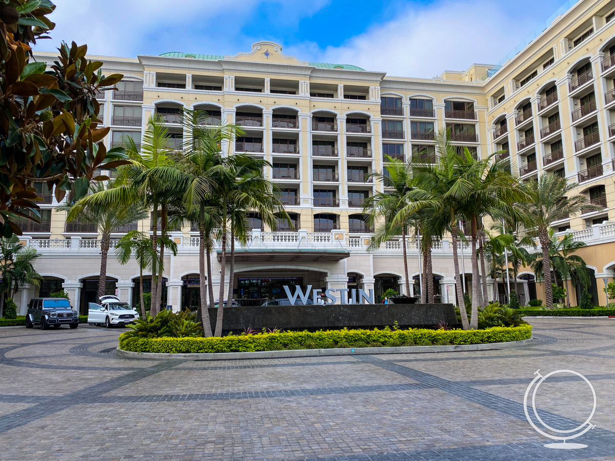 the exterior of the Westin Anaheim hotel showing building, palm trees, and Westin sign 