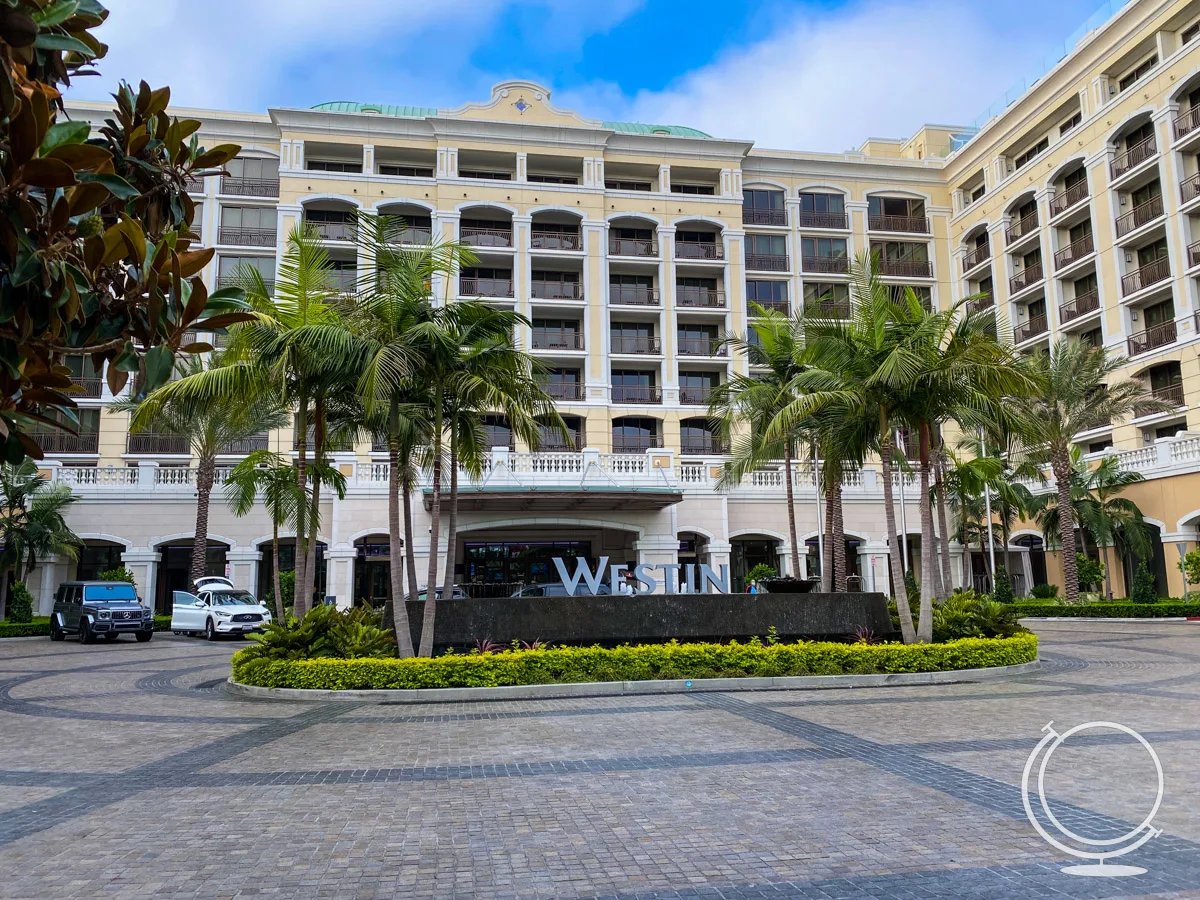 the exterior of the Westin Anaheim hotel showing building, palm trees, and Westin sign