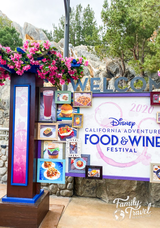 Welcome sign for the Disney California Adventure Food and Wine Festival with food pics and flowers