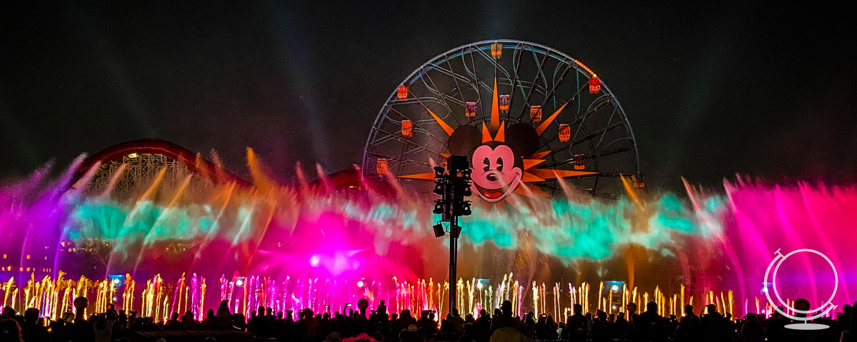 Colorful lights and water in front of Pixar Pier during World of Color