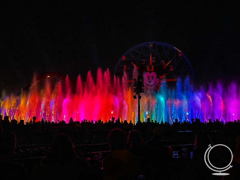 Colorful lights and water in the dark from the World of Color in front of Pixar Pier. 