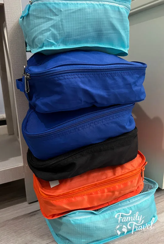 Stack of colorful packing cubes packed