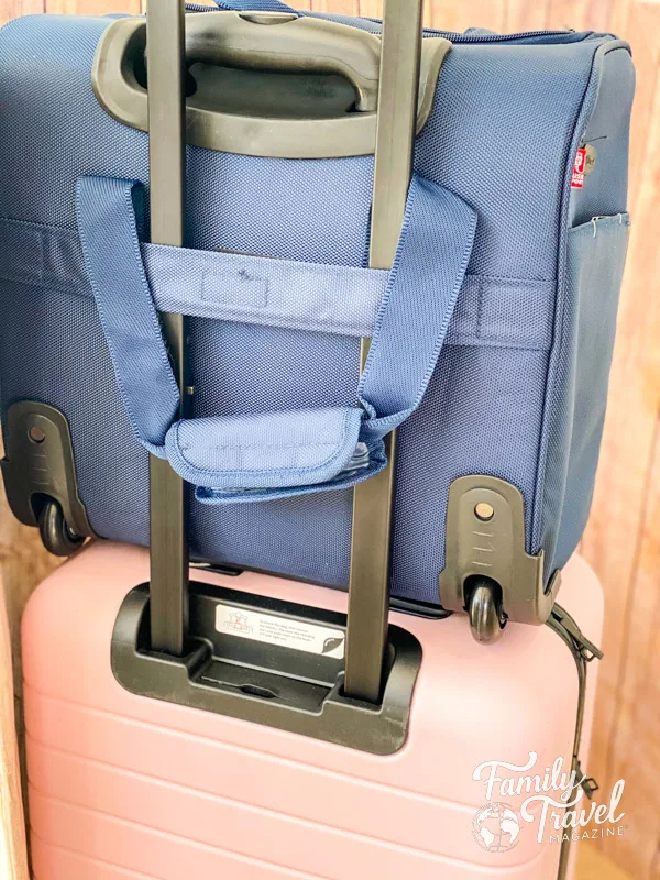 Small blue roller bag on top of pink roller bag