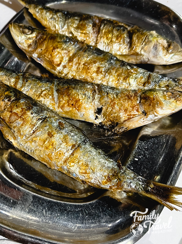 Grilled whole sardines on a plate
