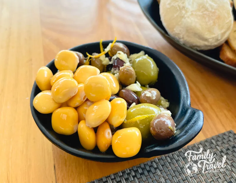 Lupini beans with green and black olives in small dish