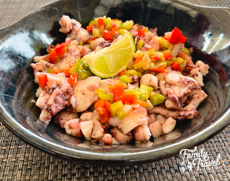 Octopus salad with lime wedge on top