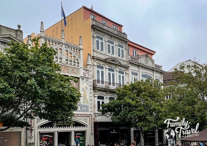 Exterior of Lello bookstore with buildings next to it. 