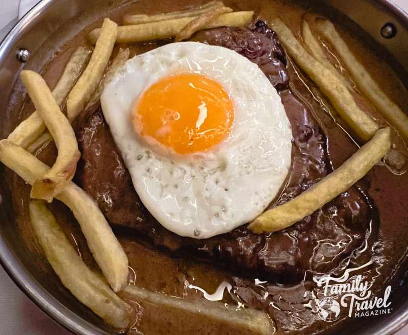 Portuguese style steak with fries and egg on top 