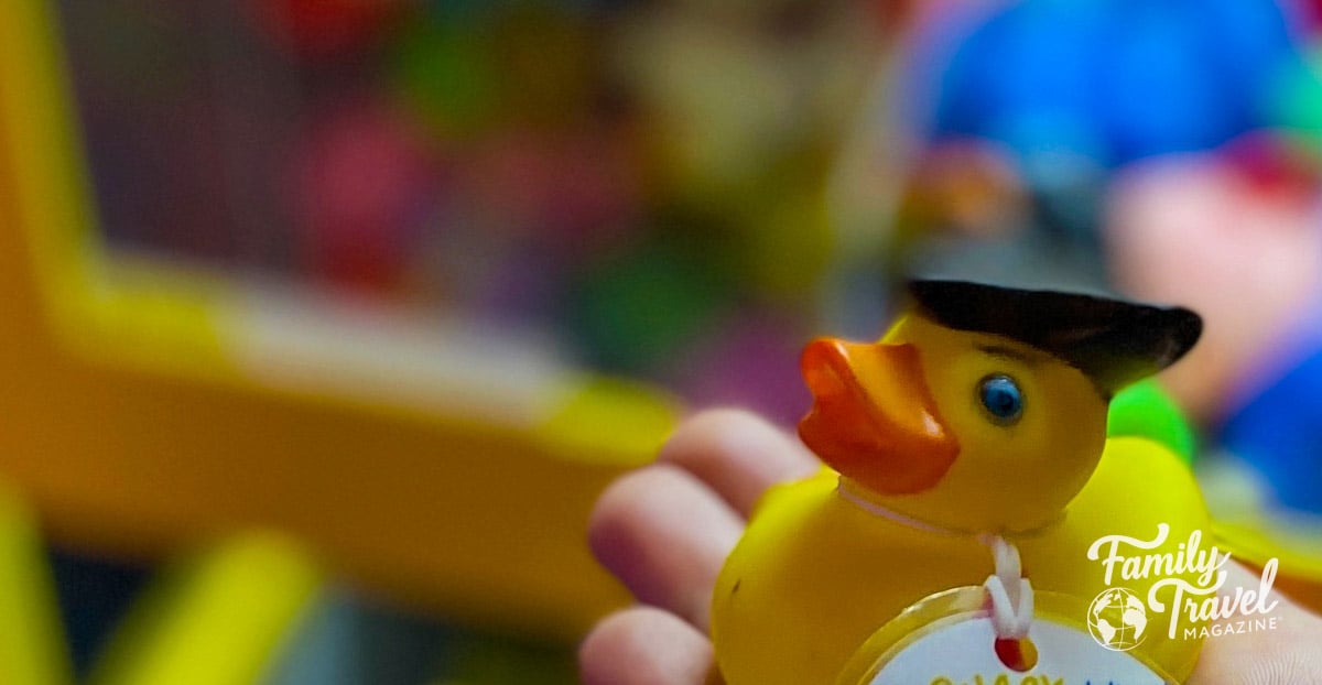 Rubber duck with black hat and a tag hanging