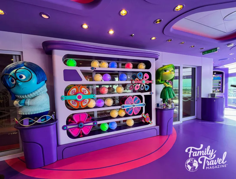 Joyful Sweets interior with statues of Sadness and Disgust next to machine with memory orbs. 