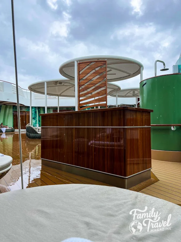 Wooden fixture, and chairs on wet outdoor deck