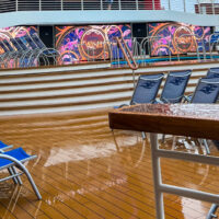 wet pool deck with deck chairs on cruise ship