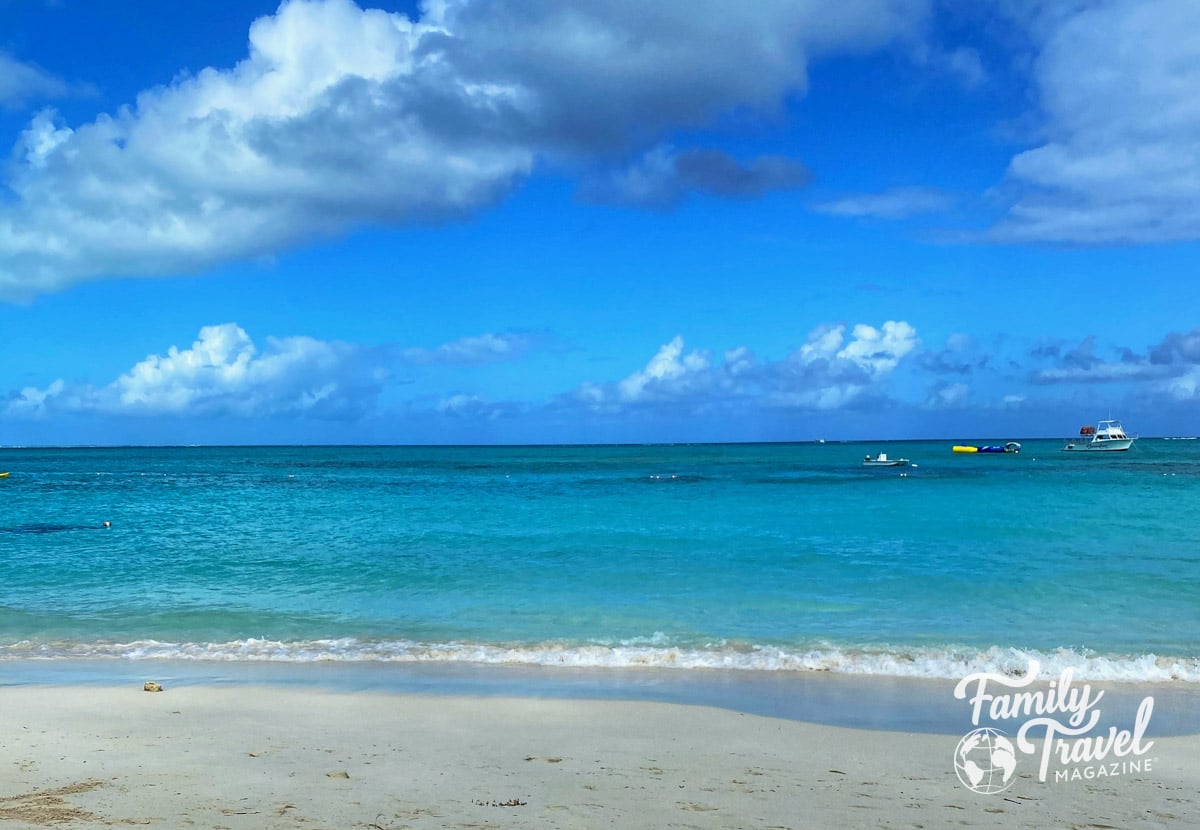 beach small boats with turquoise water and blue sky