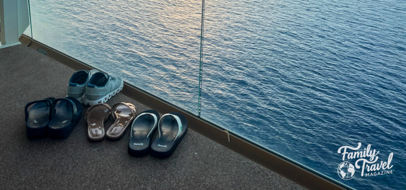 Four pairs of shoes on a cruise ship balcony