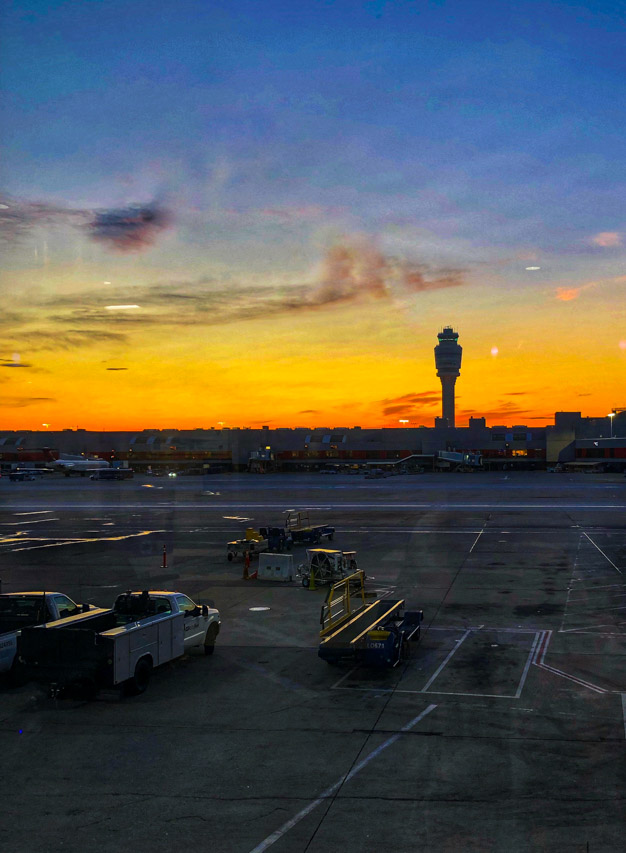 Sunrise at airport with tower in distance