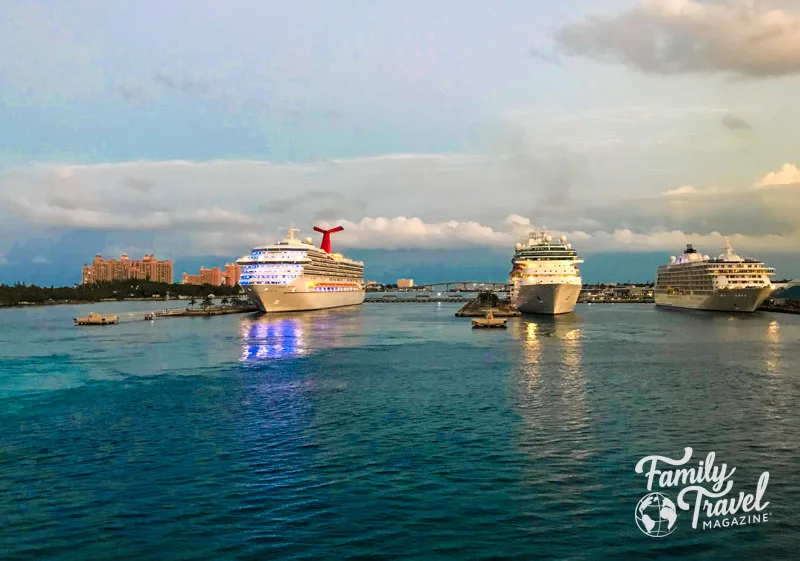 three cruise ships docked with Atlantis in the background