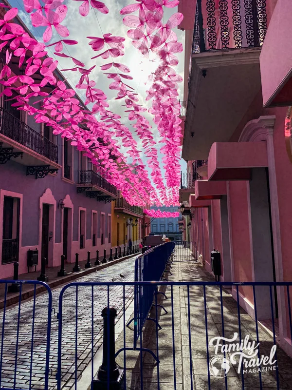 Pink butterfly garland over sidewalk in Puerto Rico