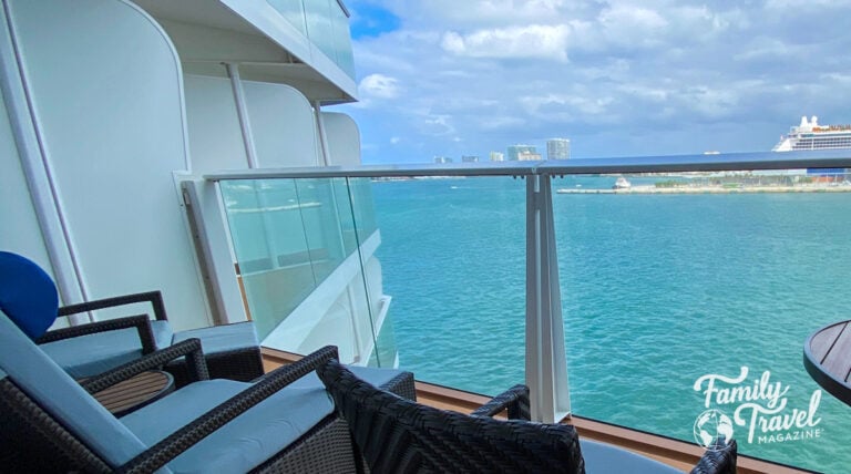 deck chairs on cruise ship balcony looking over at the dock